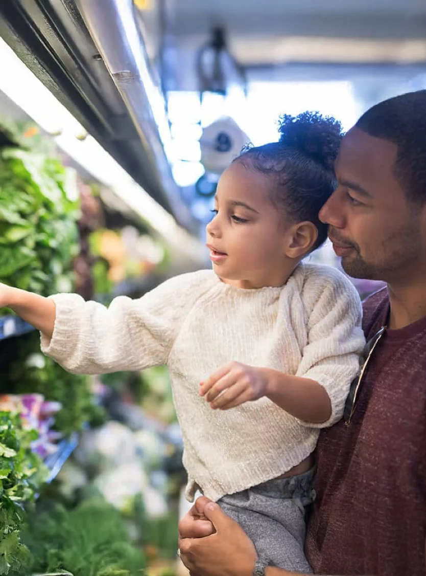 father and daughter at grocery store